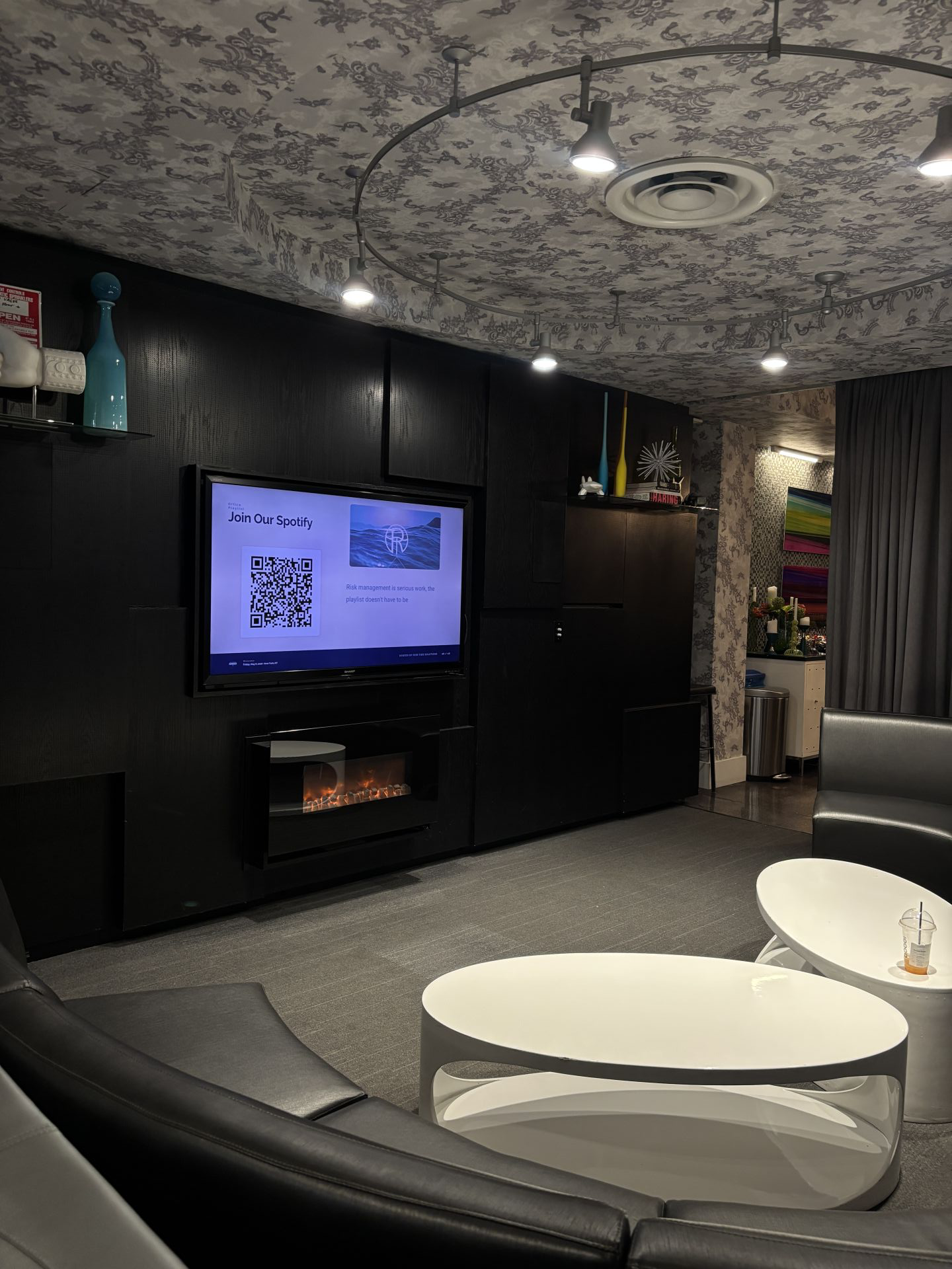 Lounge setup at a Risk Tide session, with the Risk Tide logo on the screen