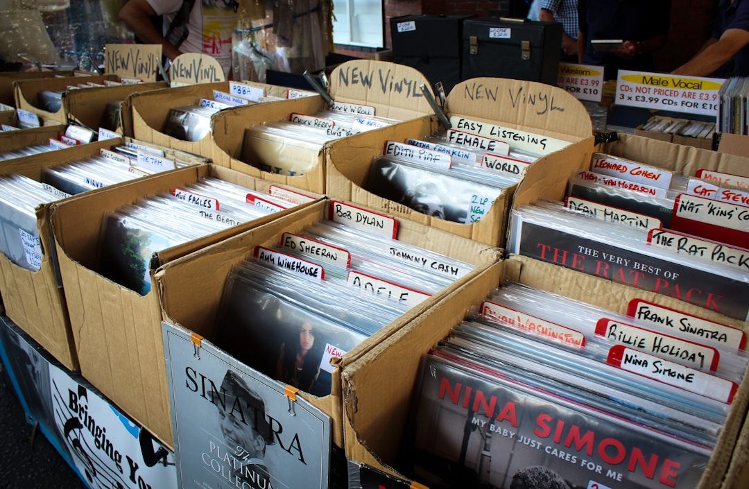 Photo of vinyl records organised in cardboard boxes in a record store.
