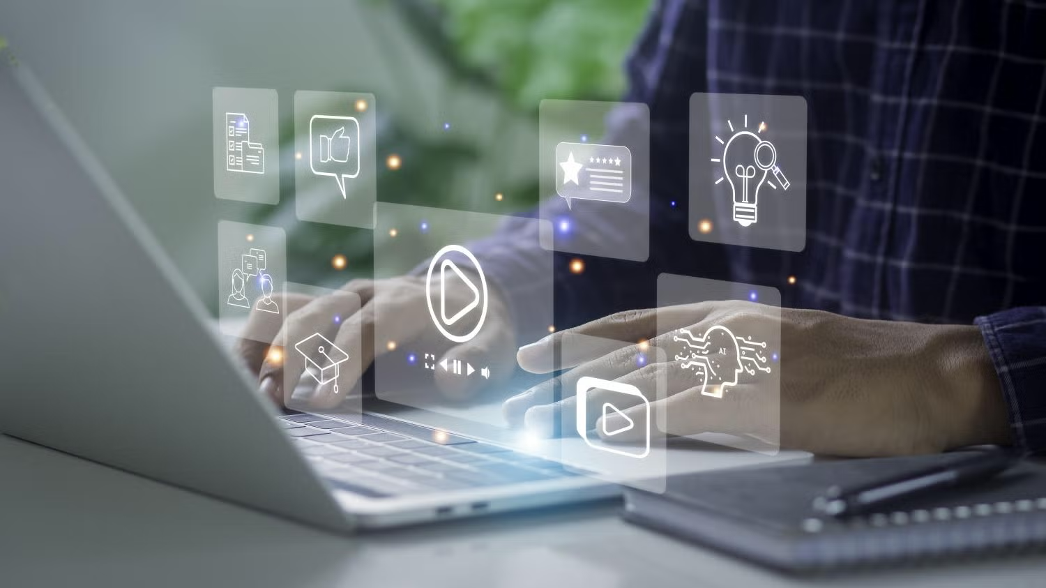 social media icons floating above laptop