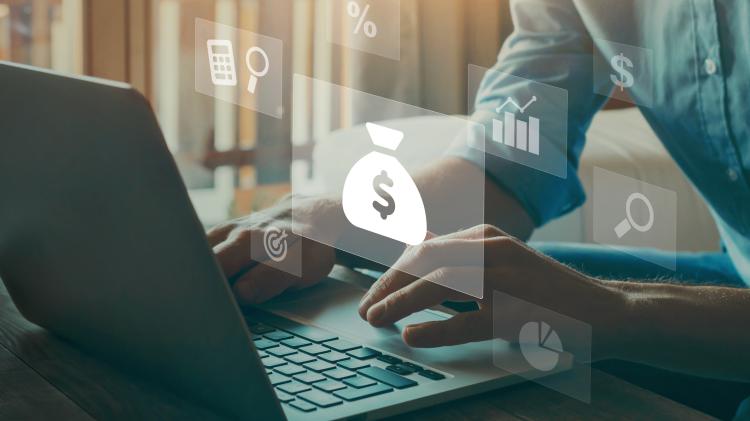 person on a laptop with finance icons