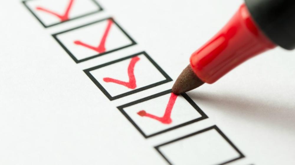 checklist with a marker checking things off
