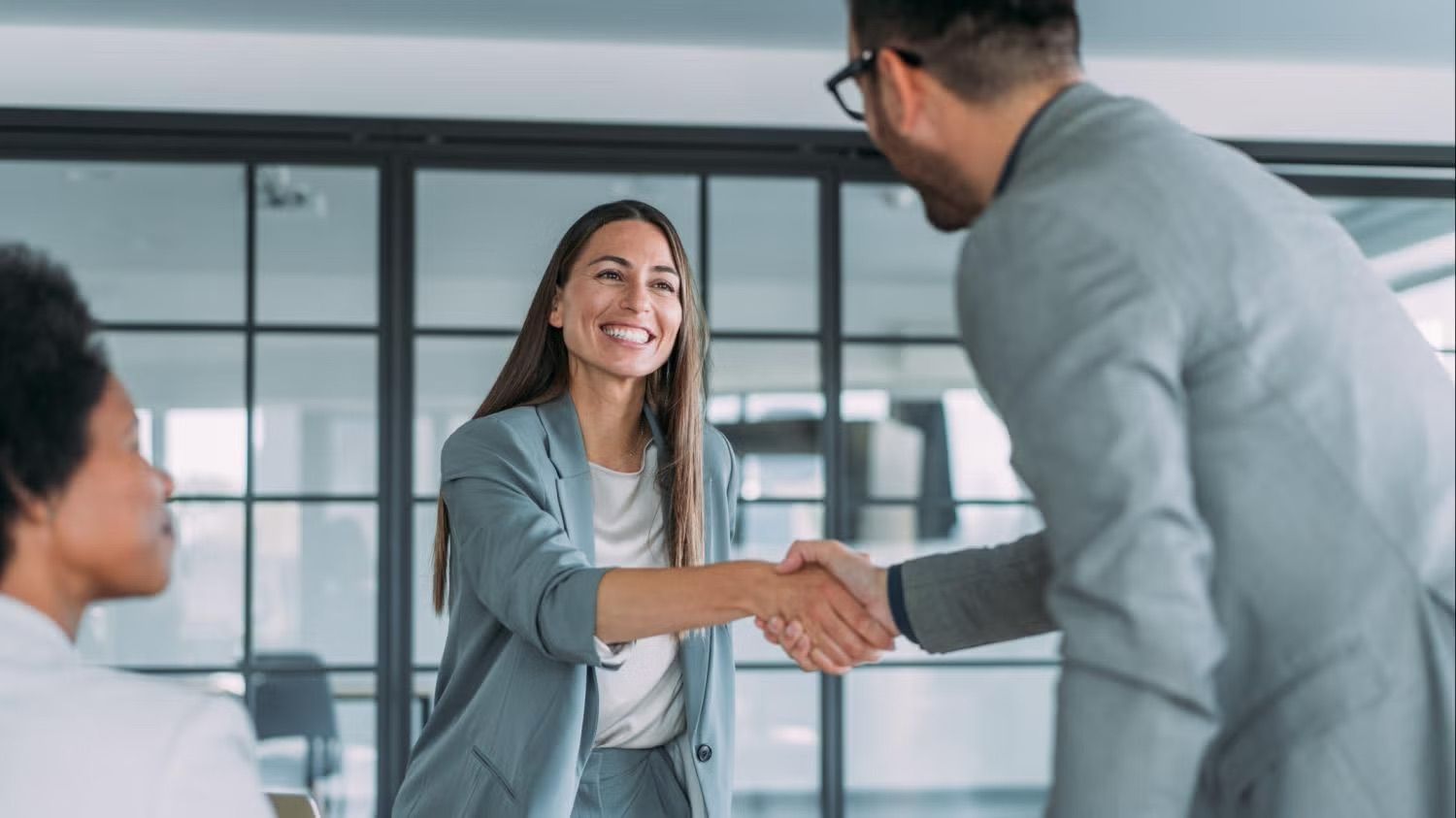 people at business meeting shaking hands