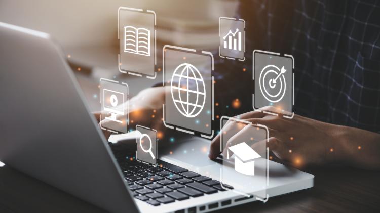 person using laptop with metrics graphics hovering above