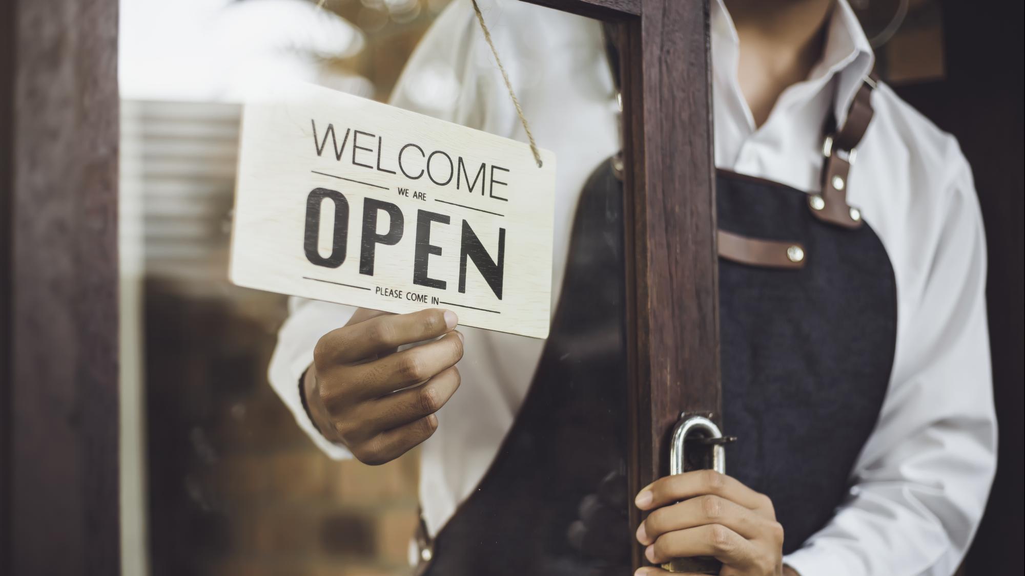 person using laptop with metrics graphics hovering above
