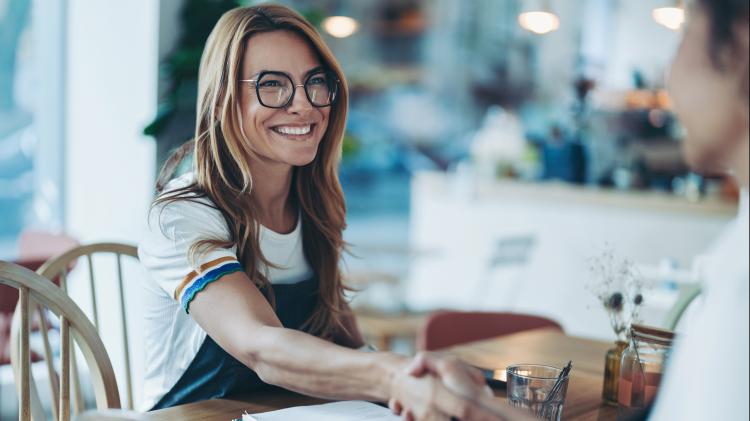 person using laptop with metrics graphics hovering above