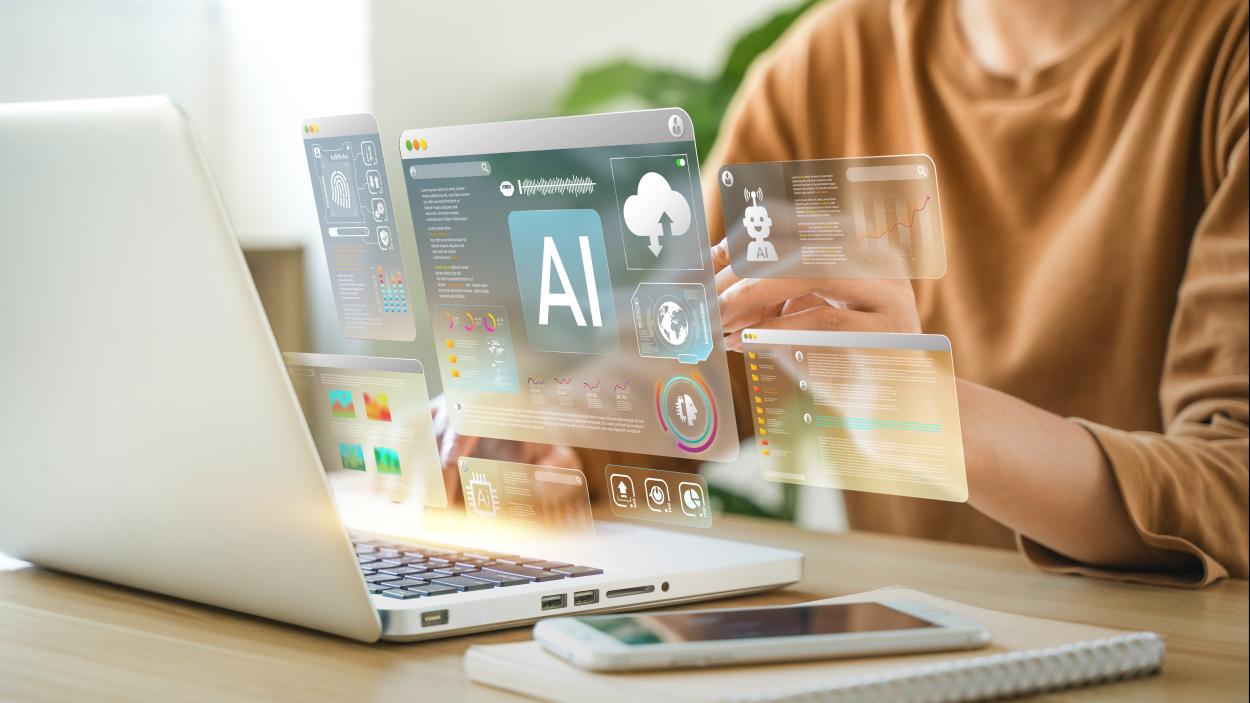 person using laptop with metrics graphics hovering above