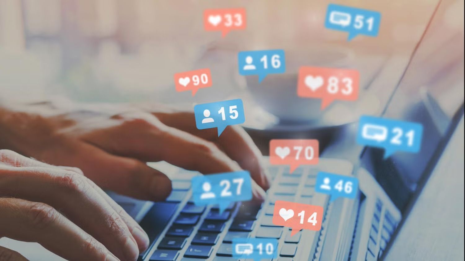 social media notification graphics hovering above computer keyboard