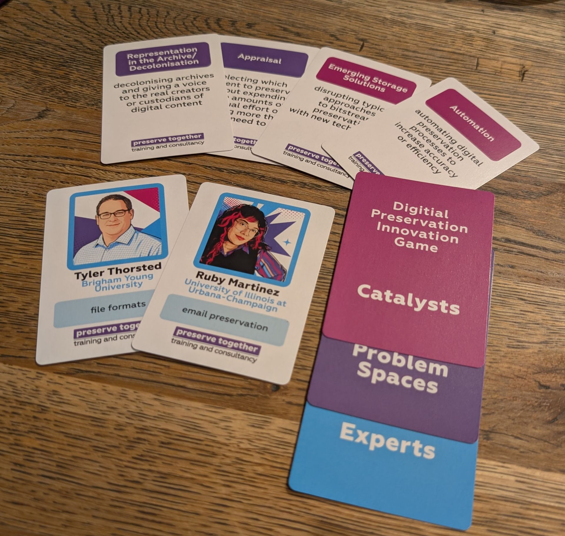 A photo of cards from the digital preservation innovation game, showing experts, problem spaces, and catalysts cards