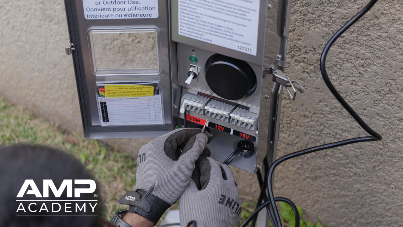 Hands working on low-voltage transformer