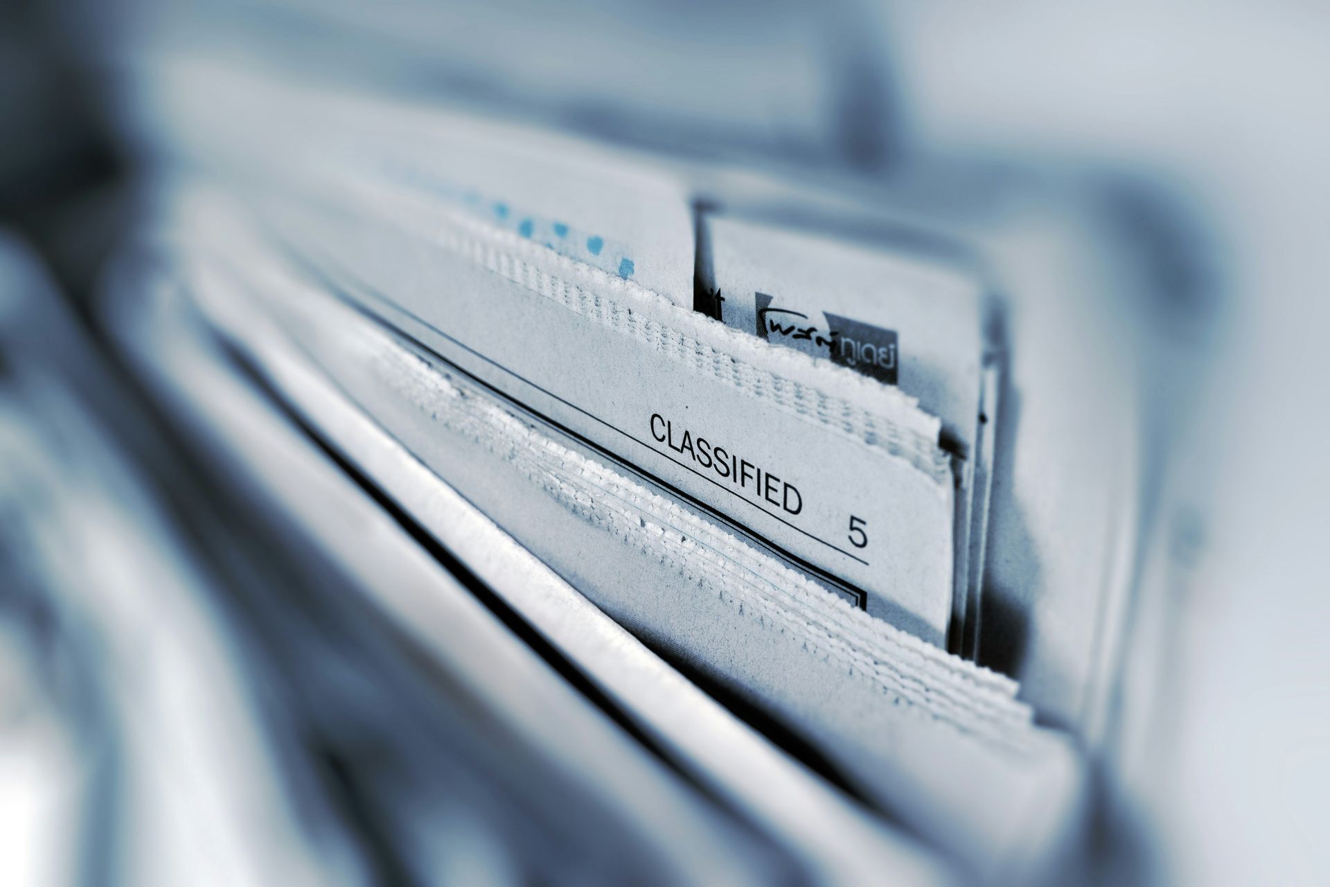 Close-up of a file drawer containing documents, with a visible file labeled "Classified." 