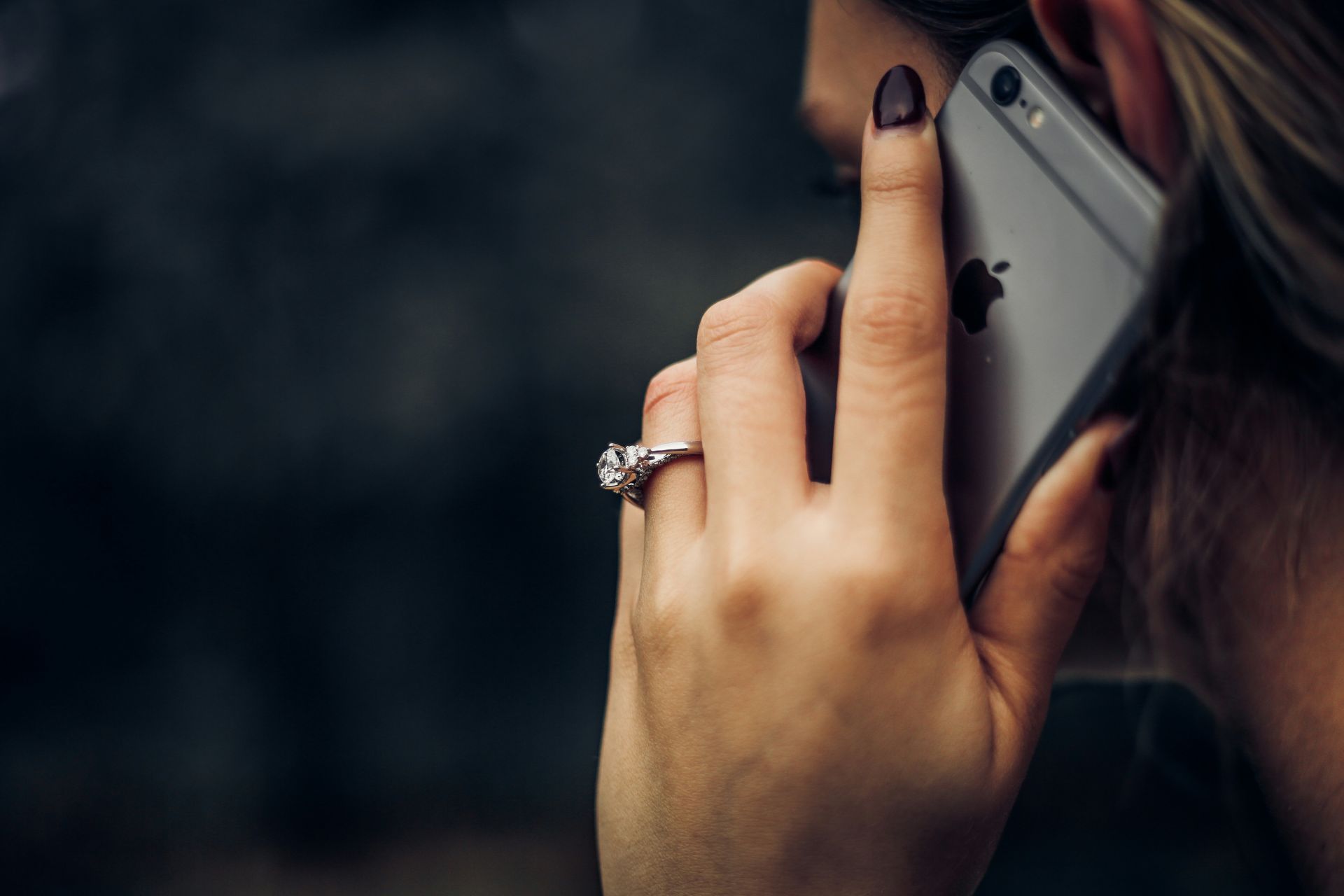 a woman holds a phone to her ear