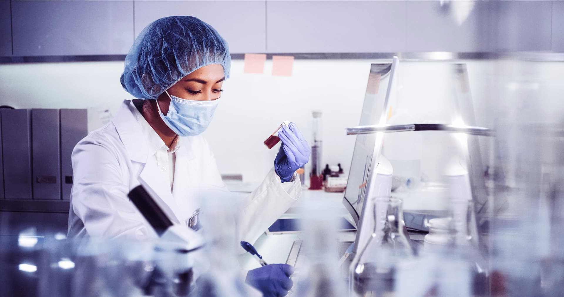 A female scientist documenting sample results in a laboratory | Fundamentals of HPLC course from Analytical Training Solutions