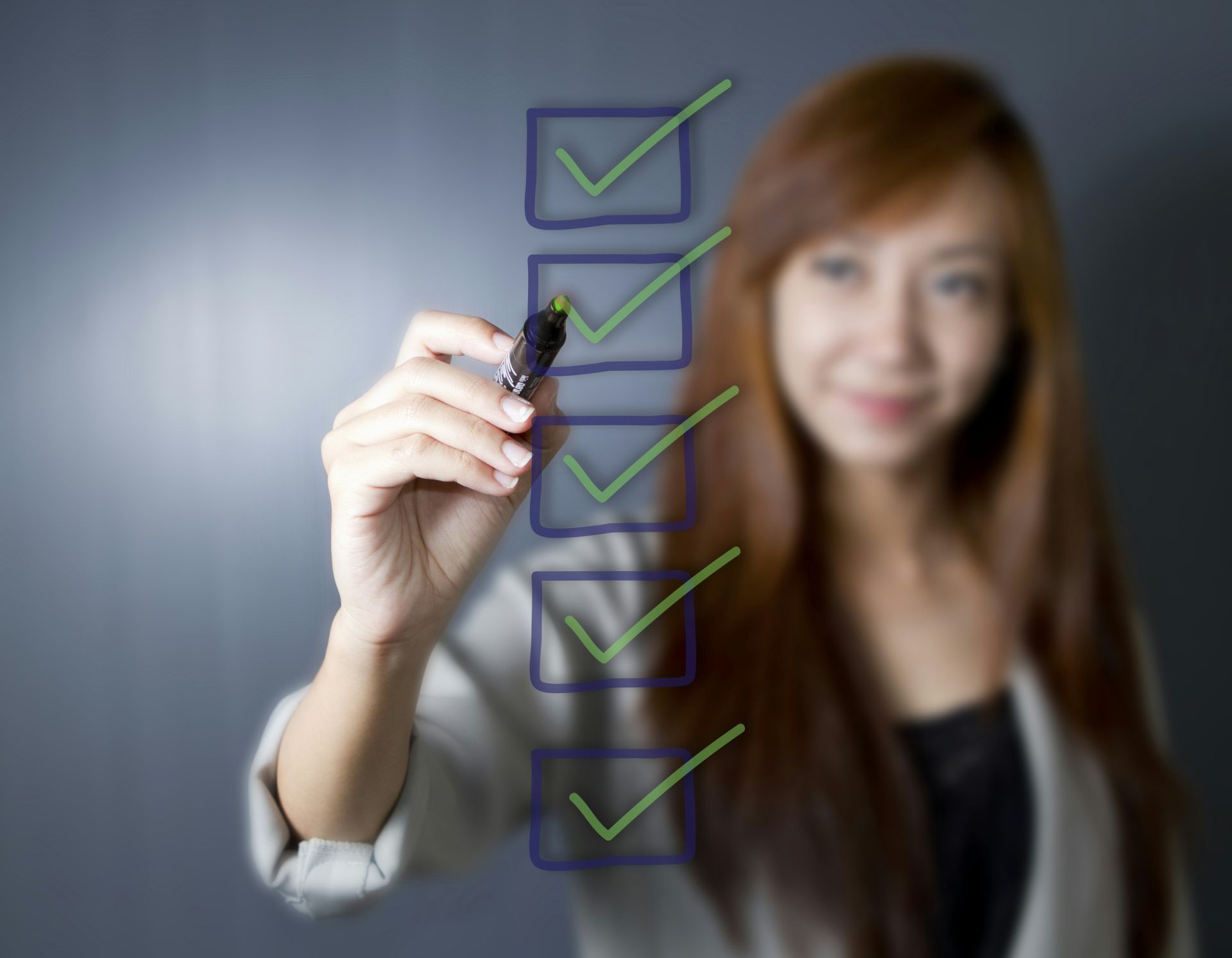 A woman ticks boxes on a checklist.