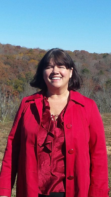 Portrait of Andrea Salzman, MS, PT, ATU Director, smiling outdoors