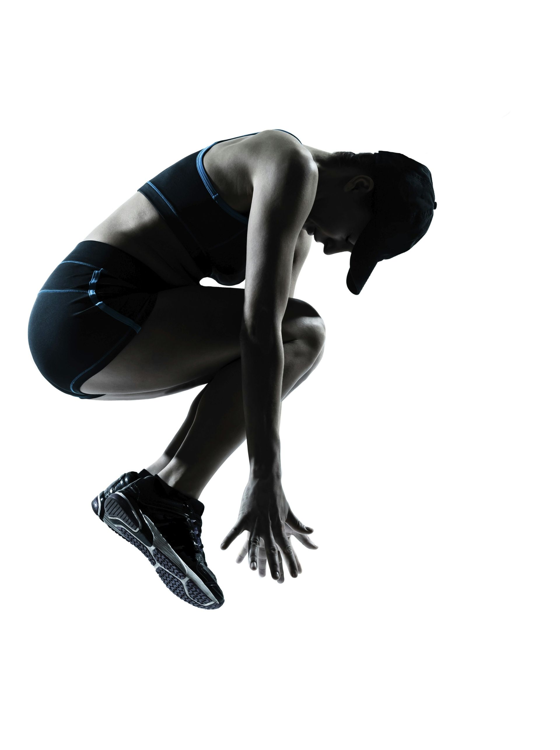 Silhouette of a person crouched, ready to jump.