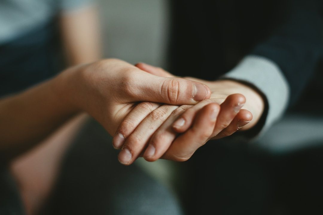 Two people holding hands