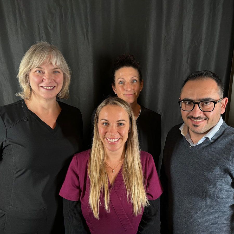 Instructor Vicki Mulyk posing with students after completing hands-on dermal fillers and neurotoxins training