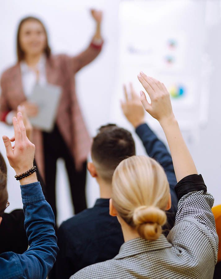 in-person training for nonprofit team with facilitator calling on members to raise their hands