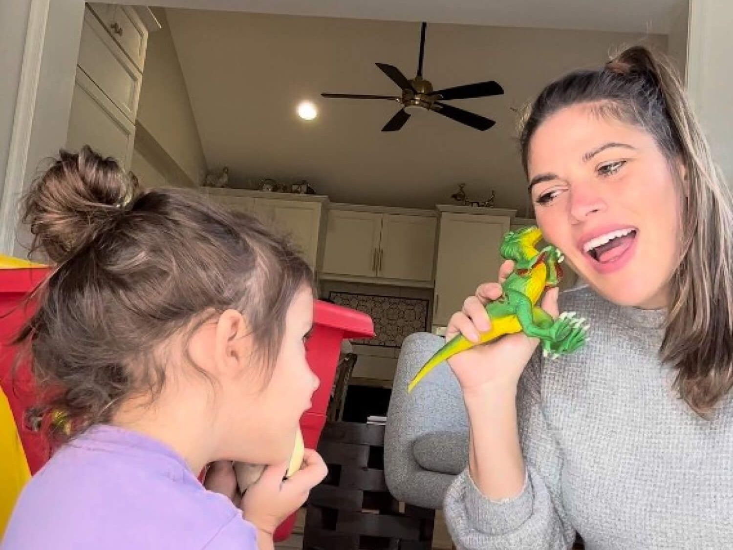 Kelly Goldberg playing iwth toys with preschooler on floor