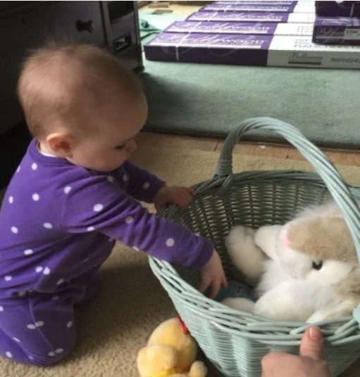 baby pulling sensory toys out of a basket