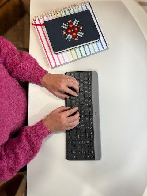hands typing on keyboard