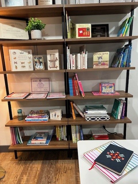 book shelf with books and planner on desk