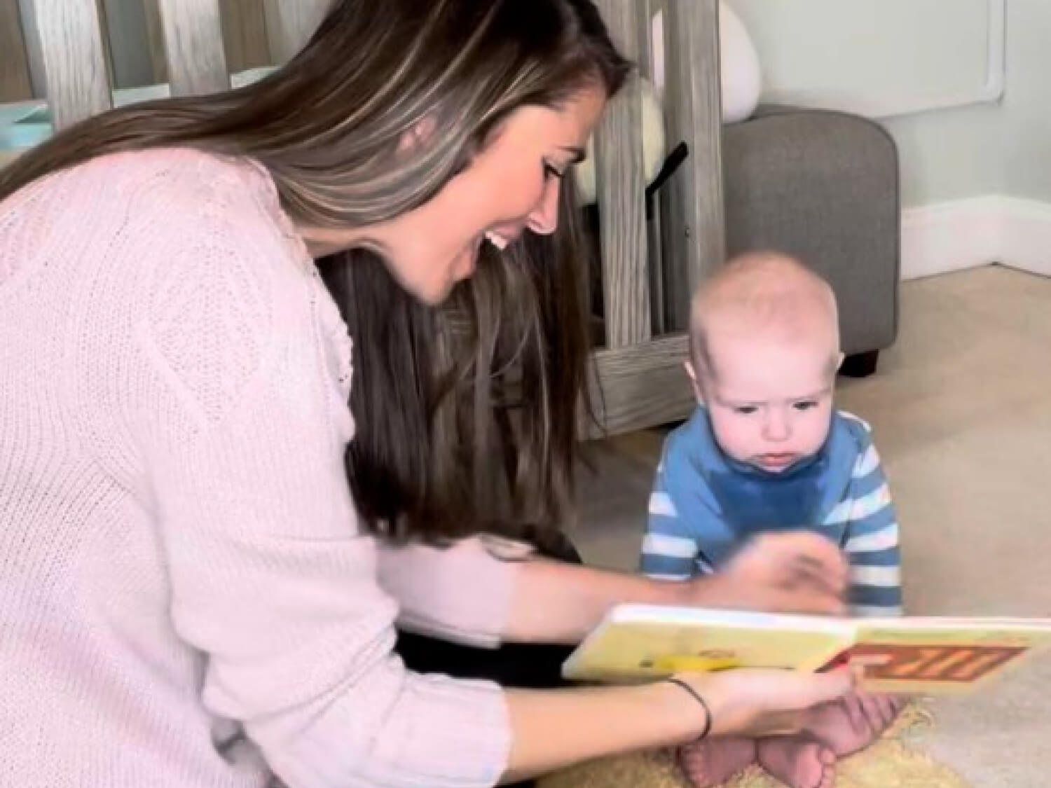 Kelly Goldberg, speech-language pathologist and early childhood education trainer reading to baby on floor