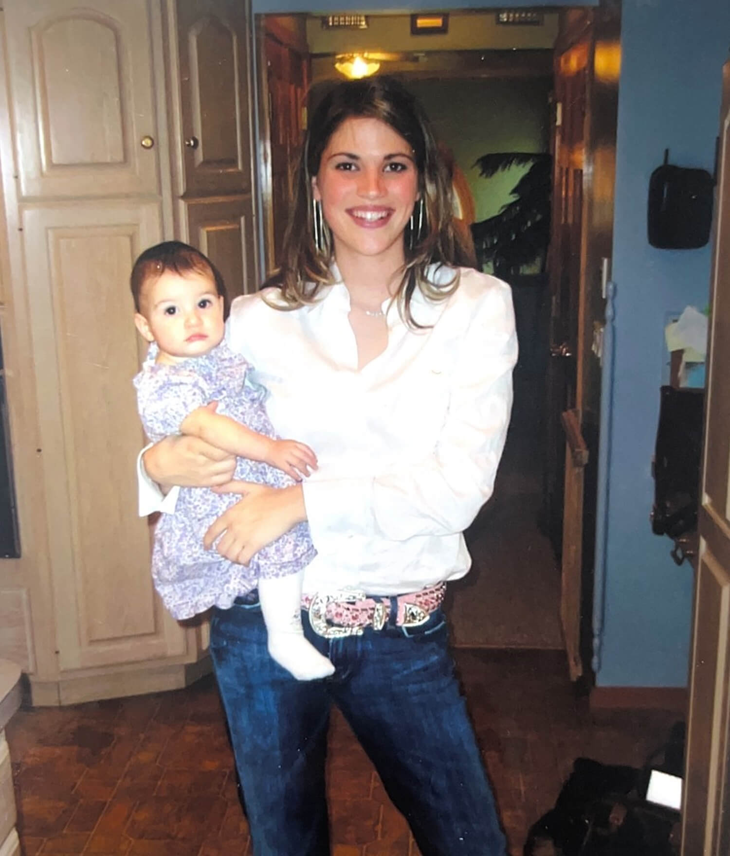Kelly Goldberg, speech-language pathologist and early childhood education trainer holding her daughter 