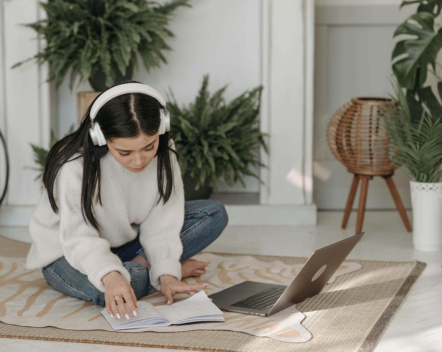 Child care provider taking a course online self paced with head phones and computer open