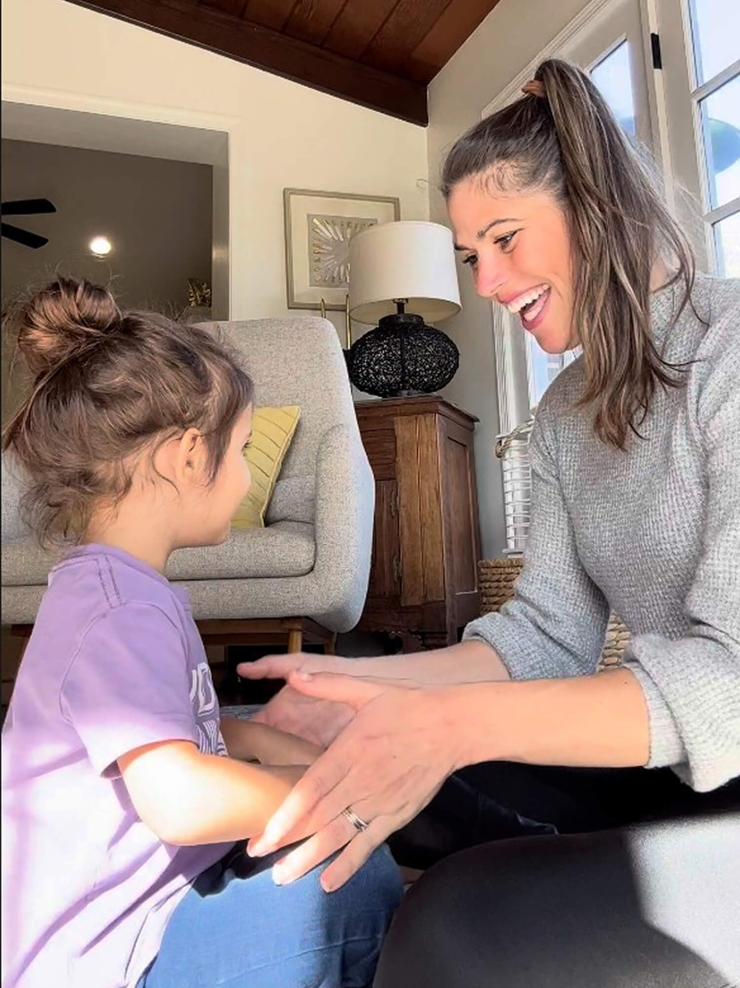 Kelly Goldberg, speech-language pathologist specializing in early childhood development playing with child while sitting on floor