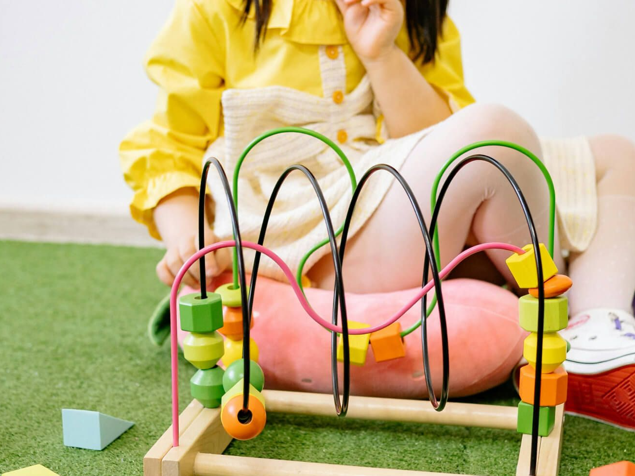 child playing with wooden toy