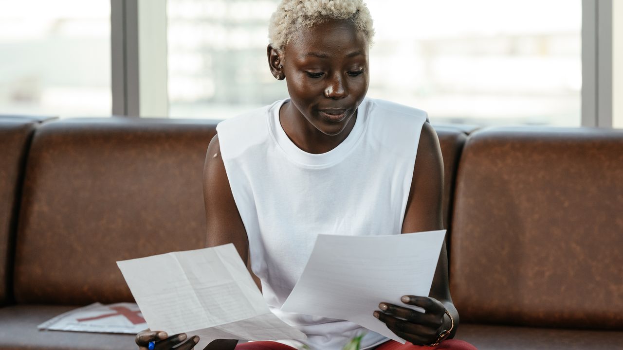 An employee reading a letter and documents at work