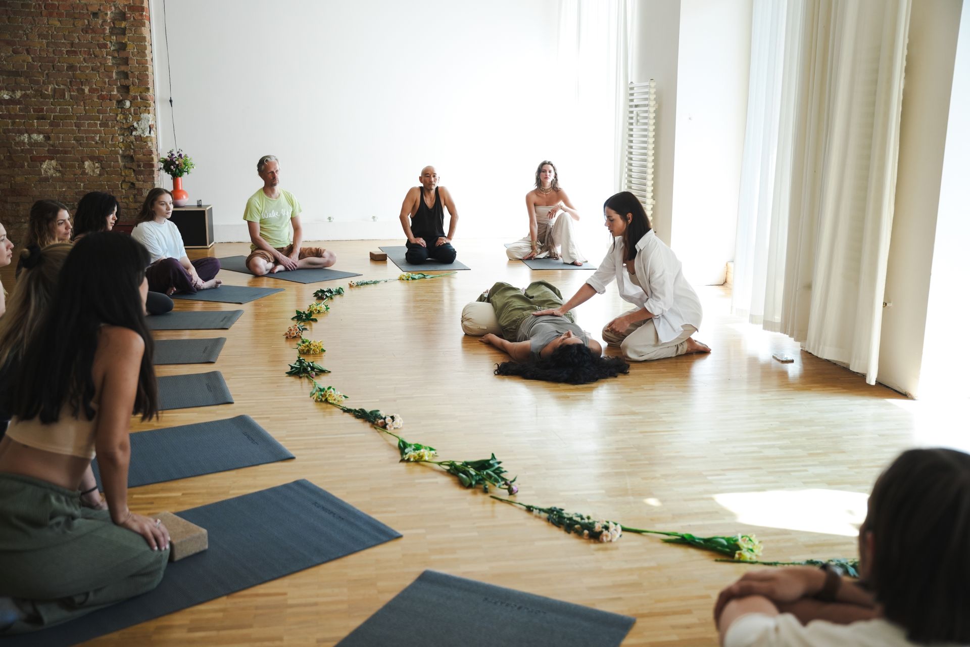 Facilitator trainees seated in a circle during practice teaching