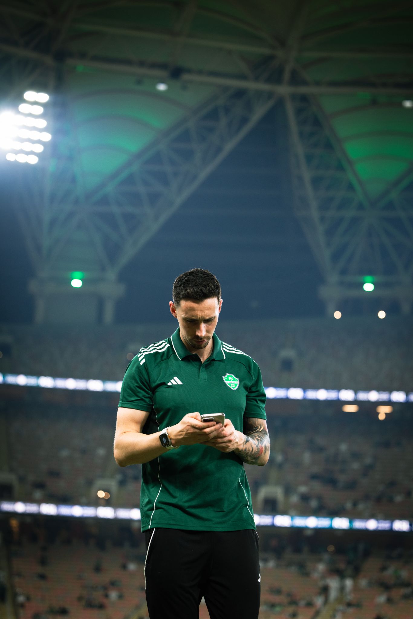 Dr Nessan Costello on the pitch at a floodlit stadium