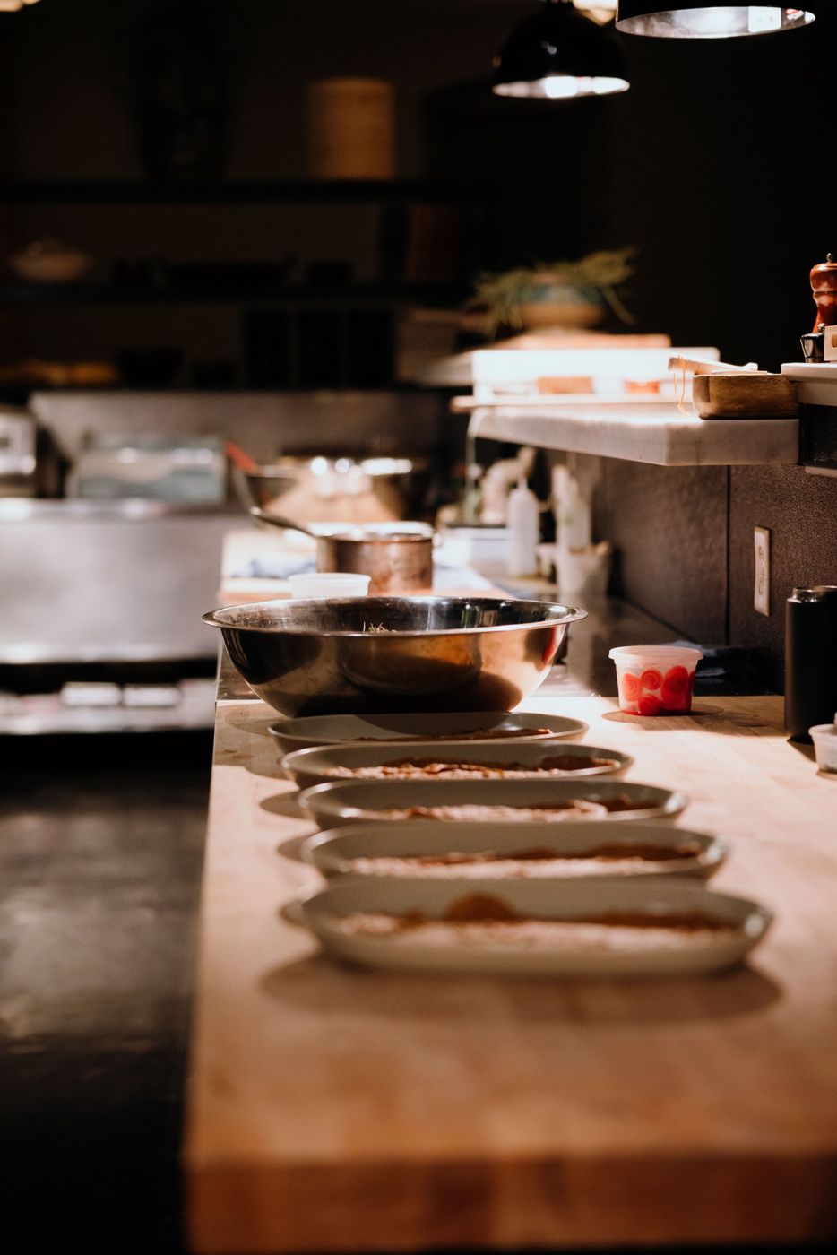 Plates lined up on a kitchen pass