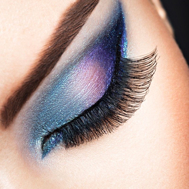 Close-up of eyelashes and colorful eye makeup