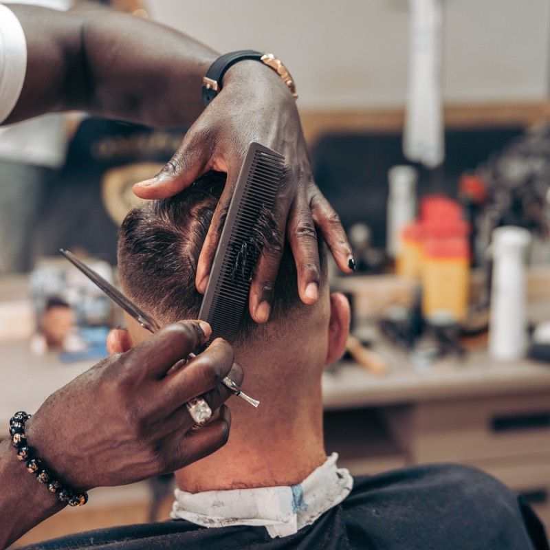 Barber cutting a client's hair