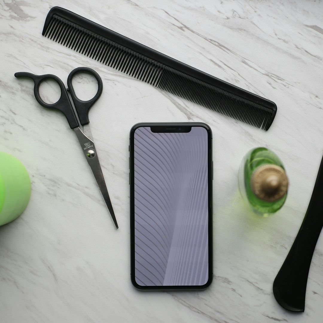 Phone with barbering and cosmetology tools for Texas TDLR continuing education.