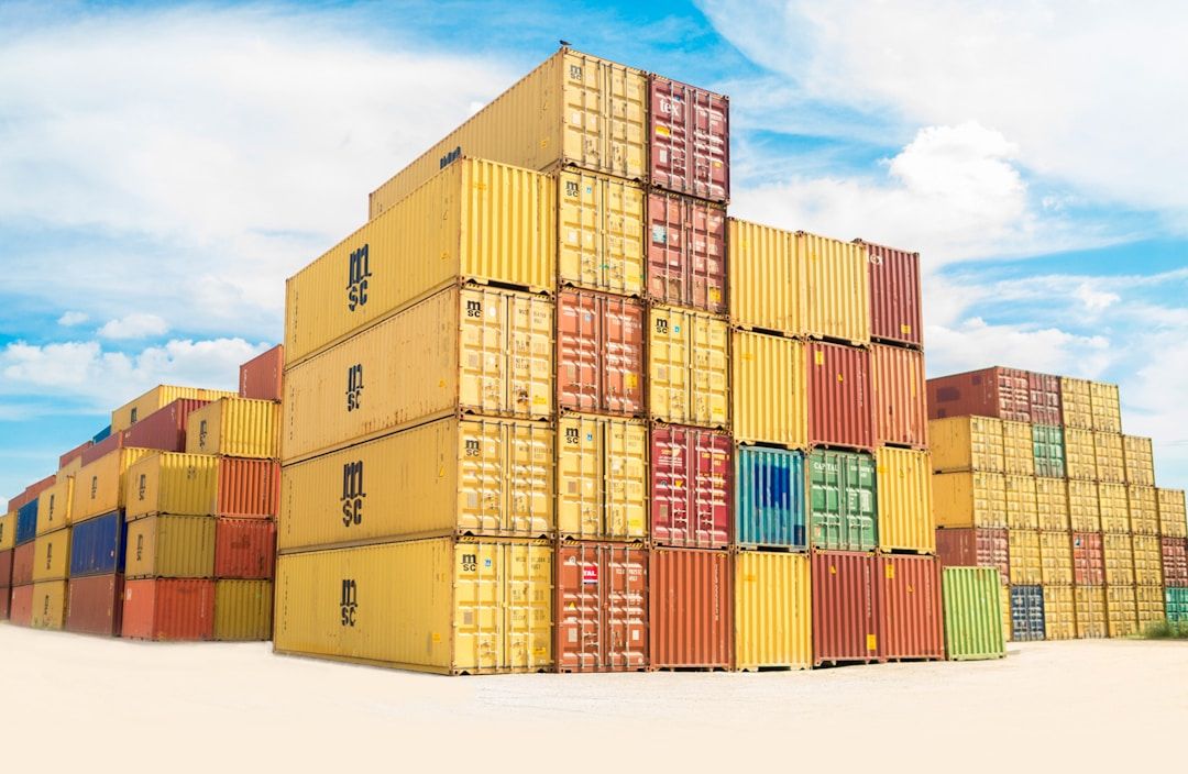 Colourful stacked shipping containers under a blue sky