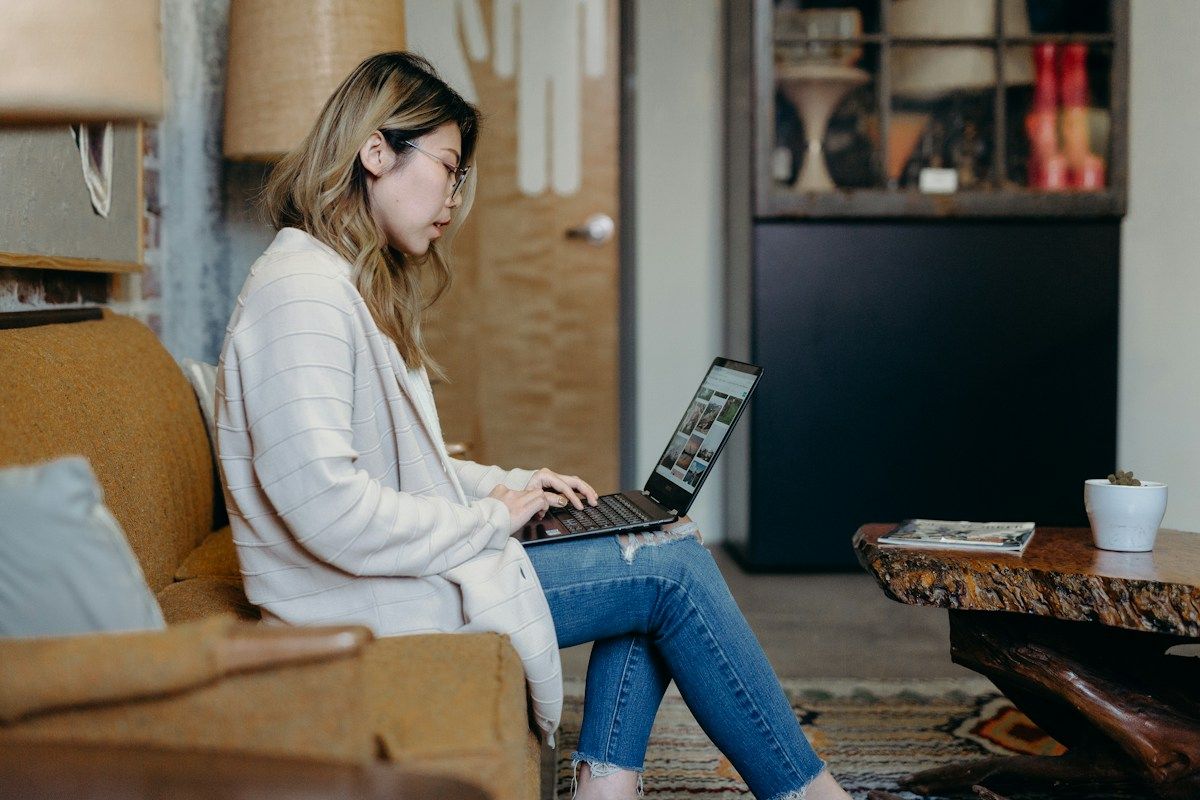 A woman learning independently on a laptop. Illustrative stock photograph.