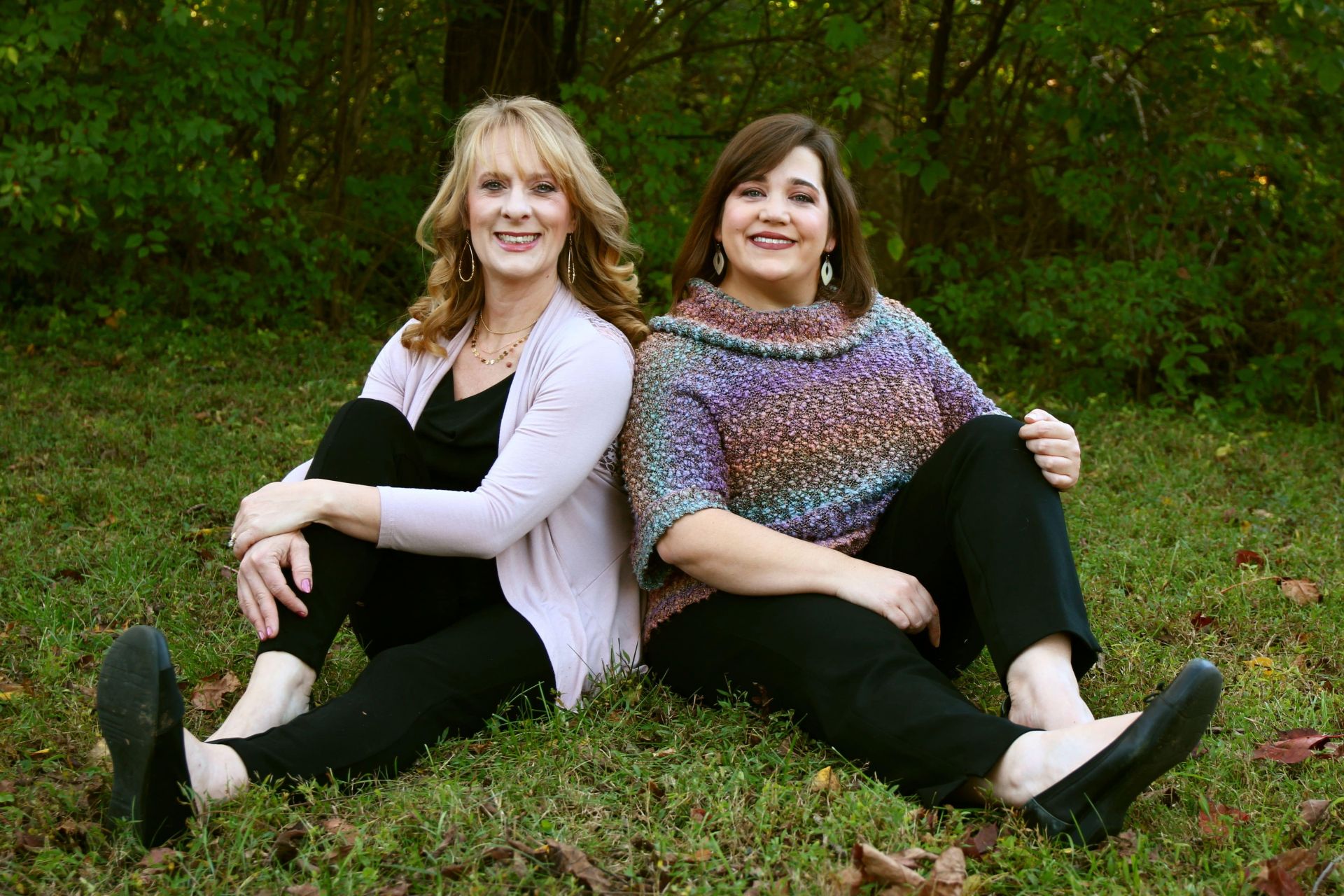 photo of Kimberly Breeden and Niccole Rowe sitting in grass, side by side 