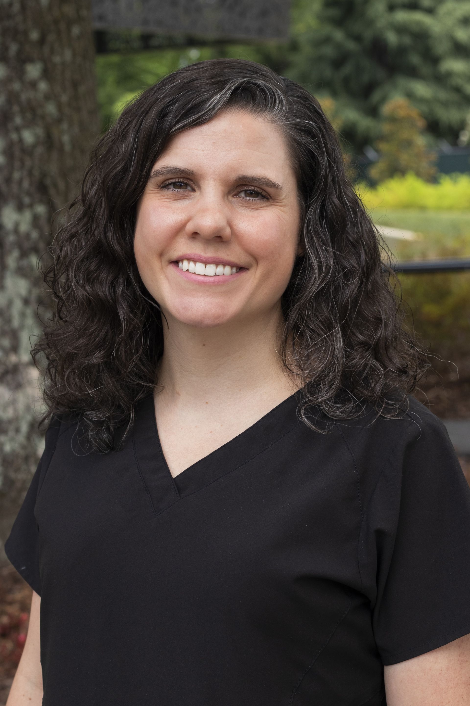 A smiling black woman in a natural background