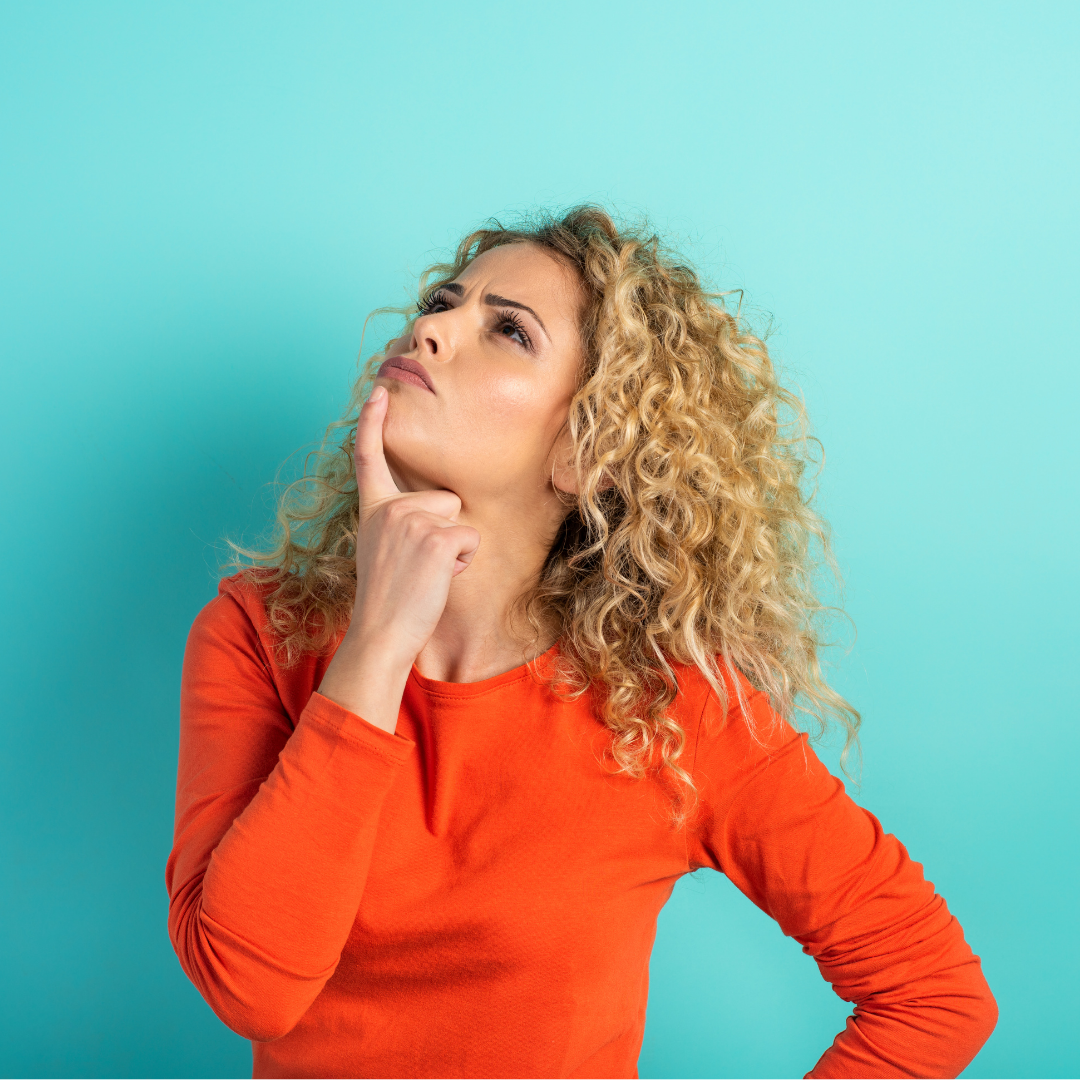 Image of a woman in a red shirt looking questioningly upwards. on a blue background