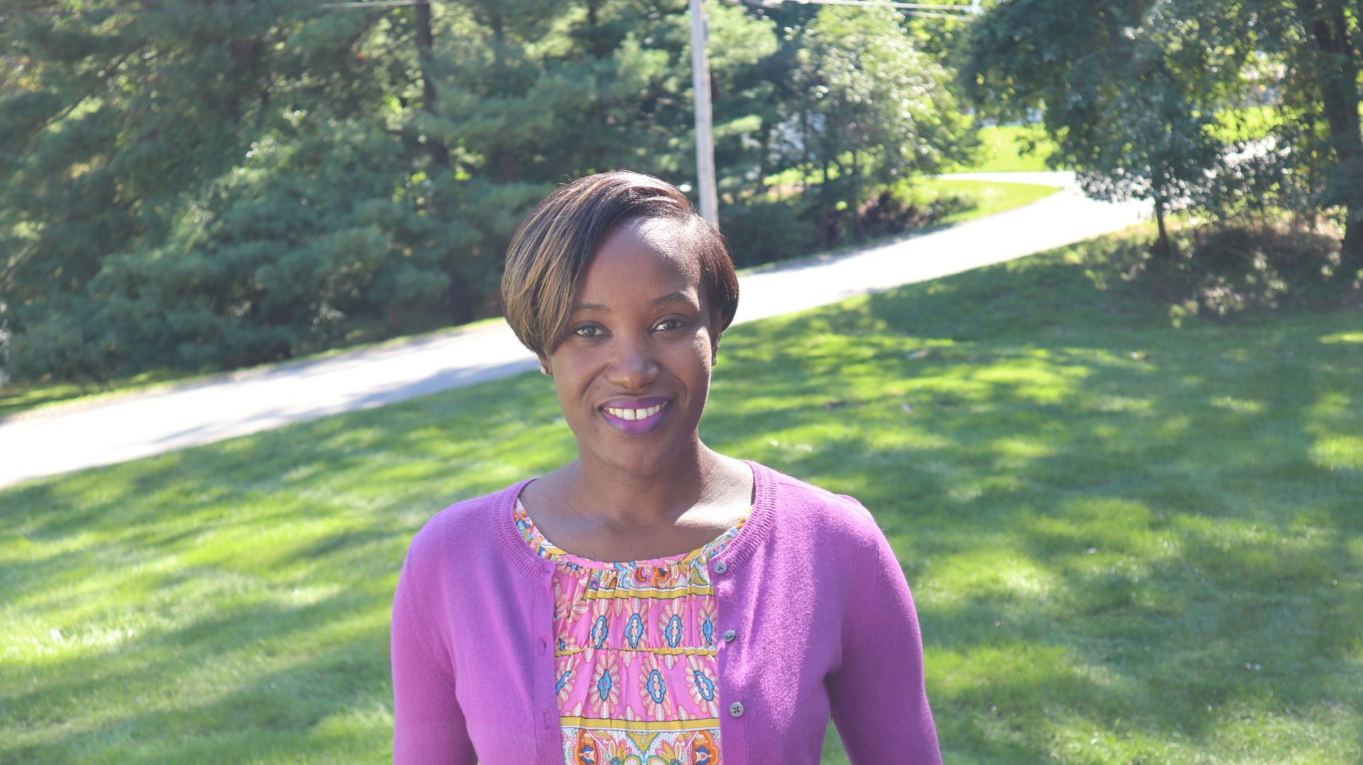 A smiling black woman in a natural background