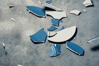 Pic of blue and white broken dish on a grey background