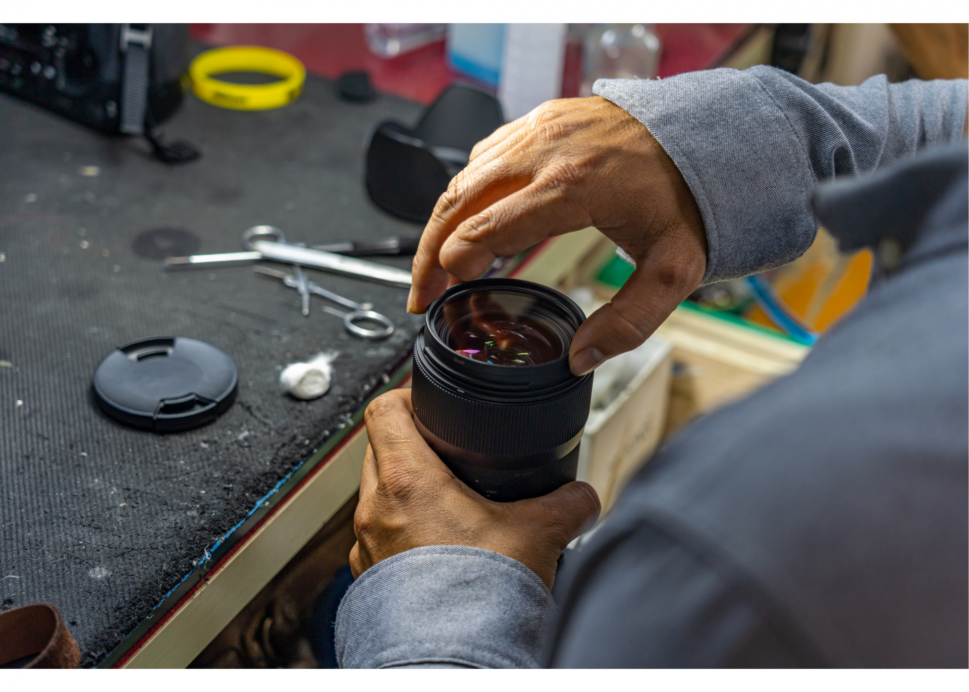 man's hands  holding a flashlight and taking it apart 