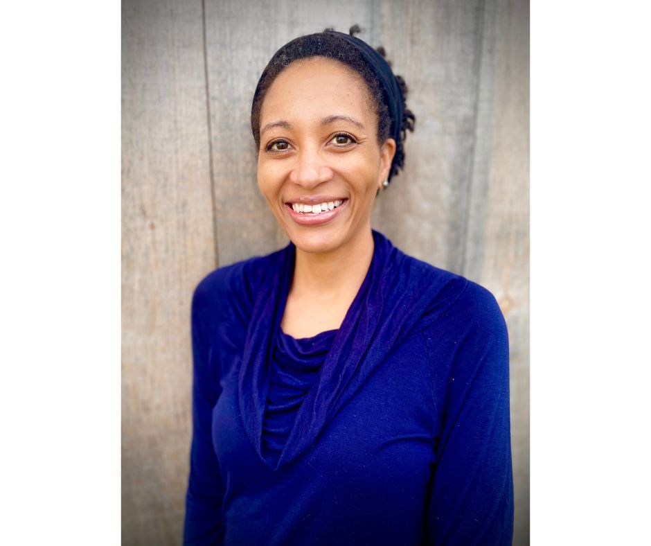 A smiling black woman in a natural background