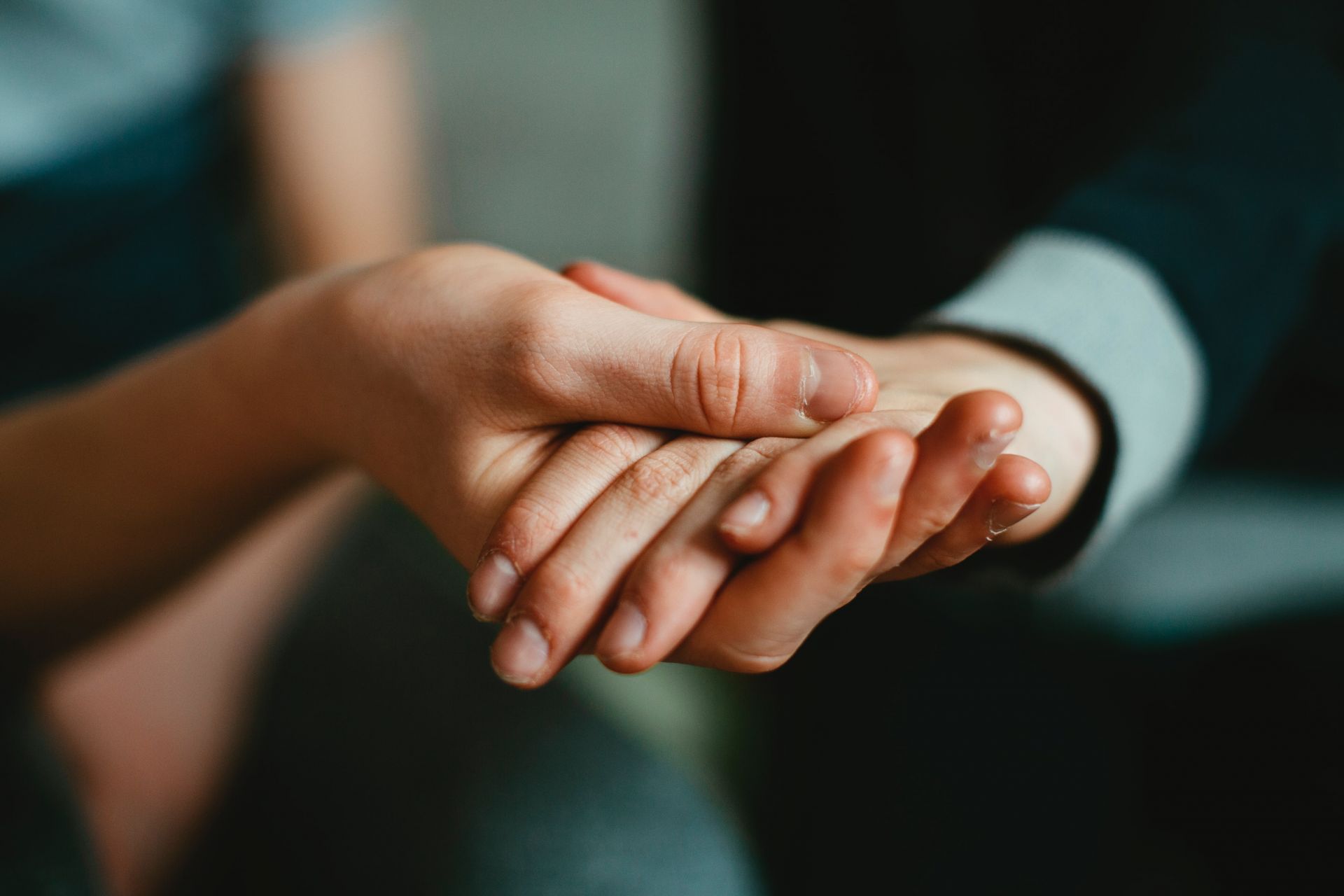 photo of two hands holding each other 