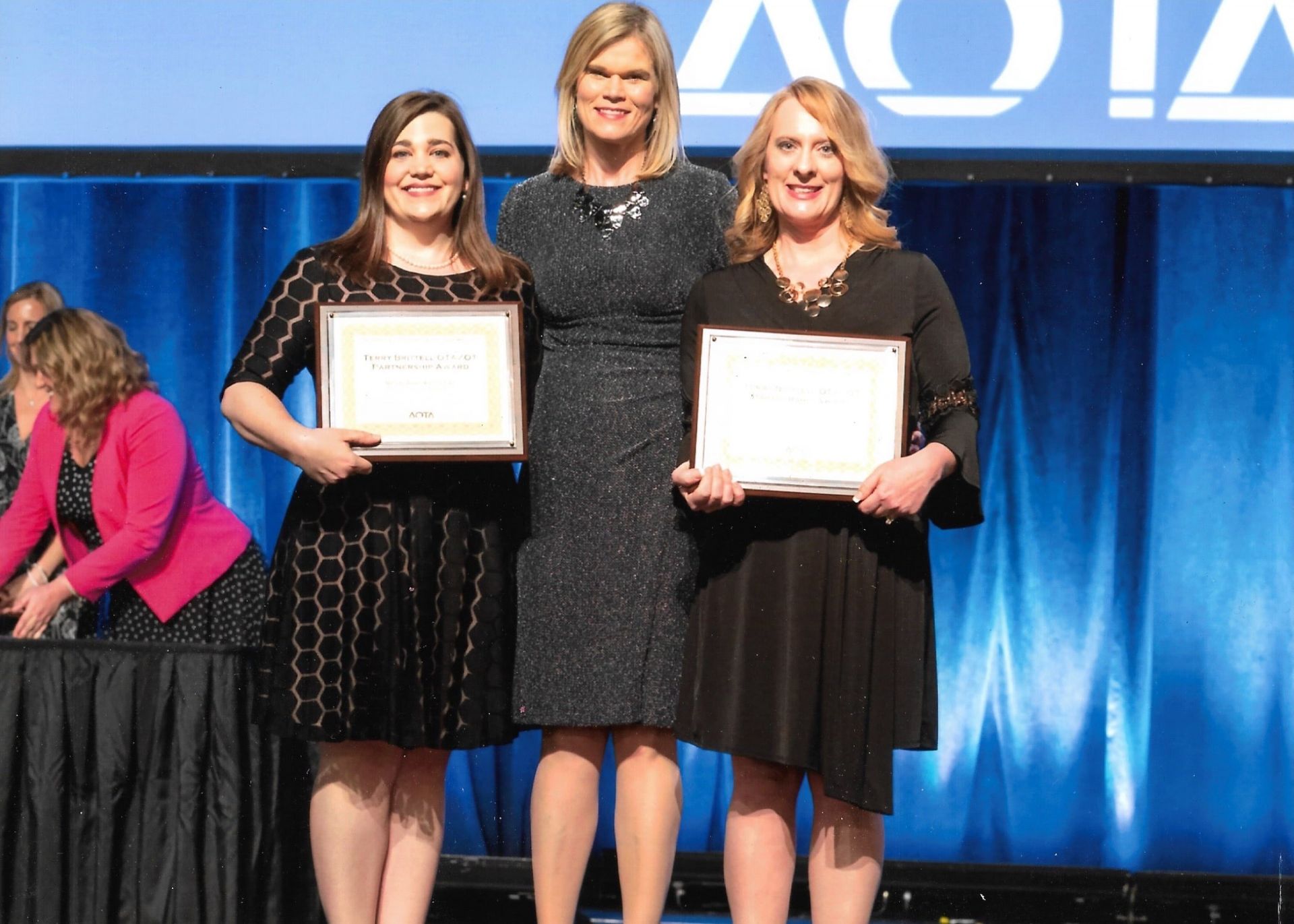 photo of Niccole Rowe and Kimberly Breeden accepting AOTA award 2018