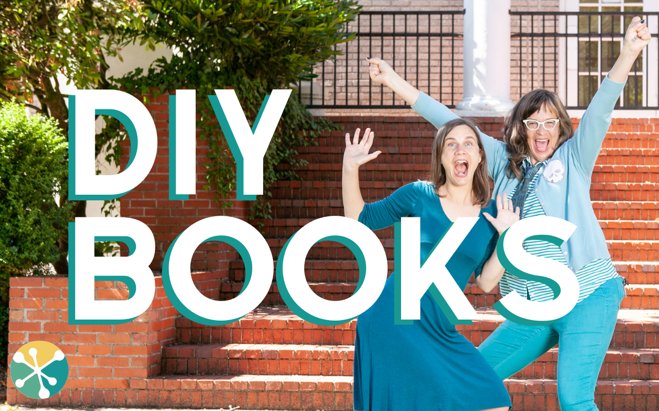 image of two women (JR & JS) with their hands up and excited faces behind the worlds DIY BOOKS